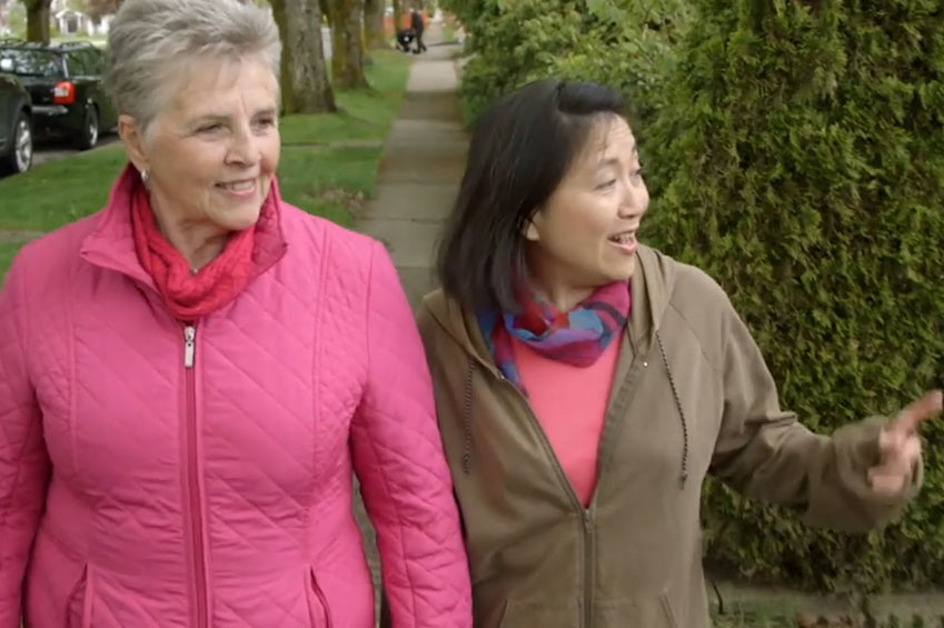 Stroke survivor and caregiver out walking.